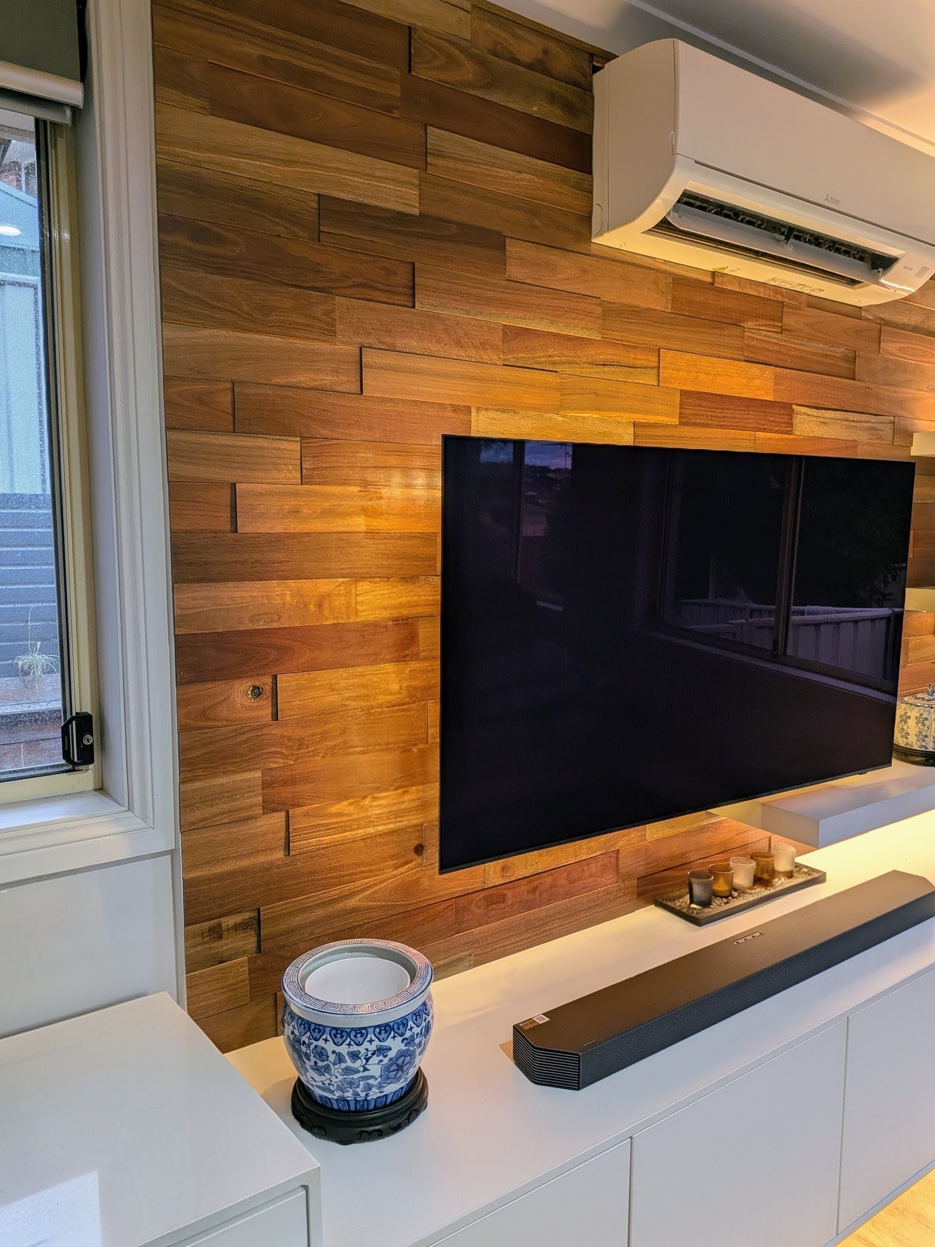 Modern wooden feature wall installation with premium timber panels and custom built TV wall unit