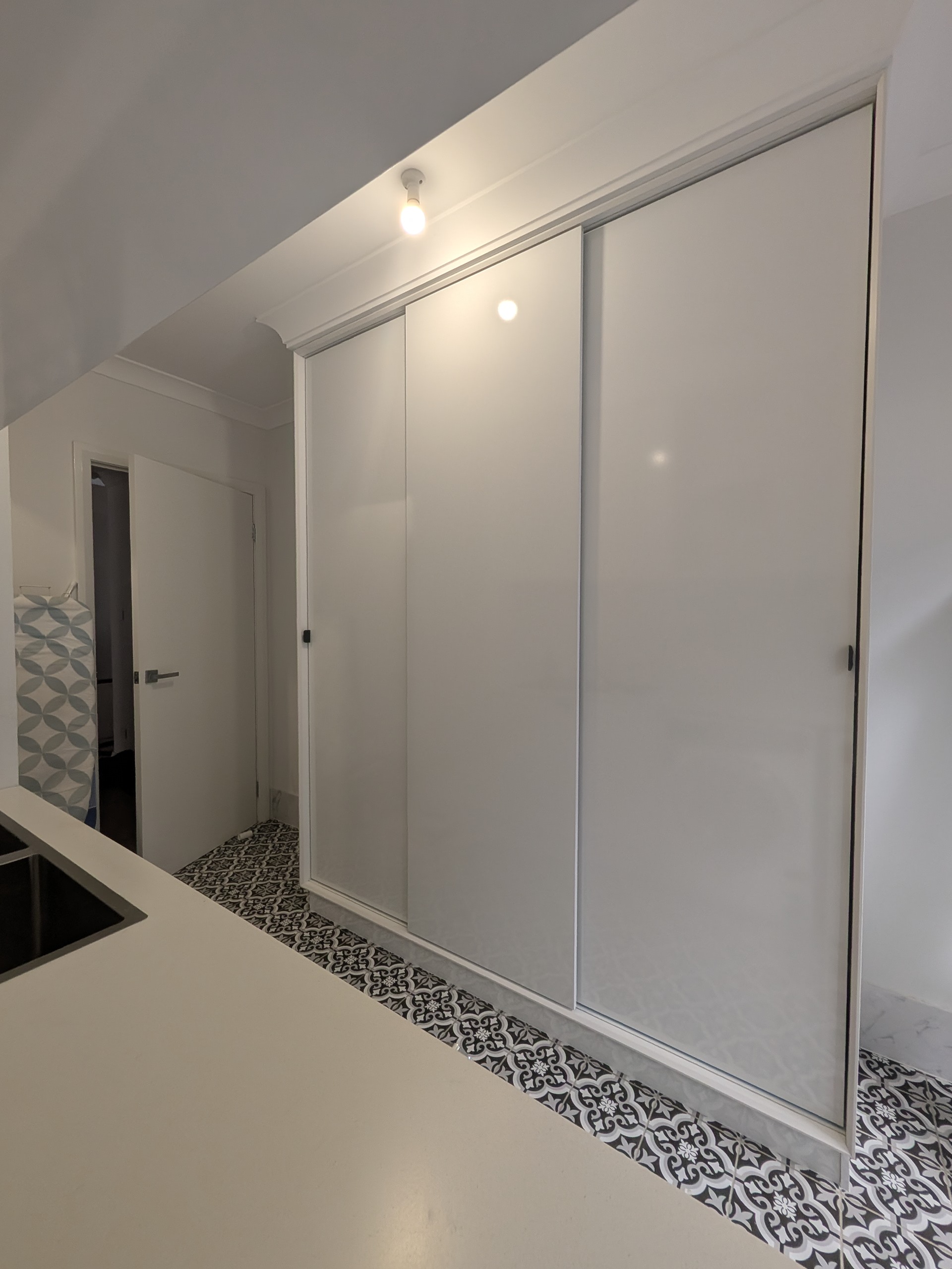 White custom sliding wardrobe with shark nose finger pull detail in Shellharbour NSW by Mojo Craftsman
