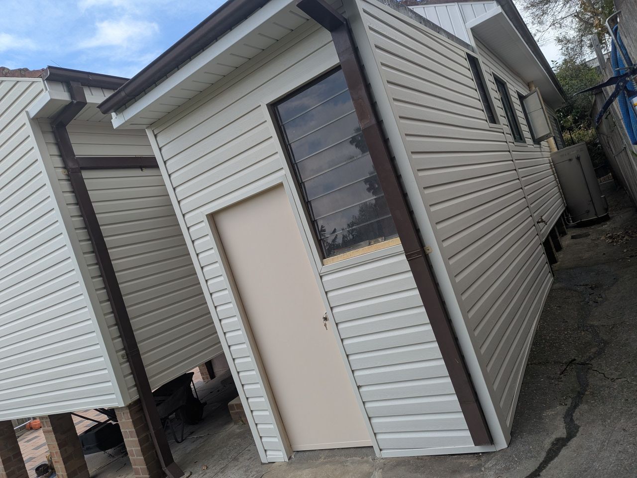 Exterior home makeover with modern cladding installation