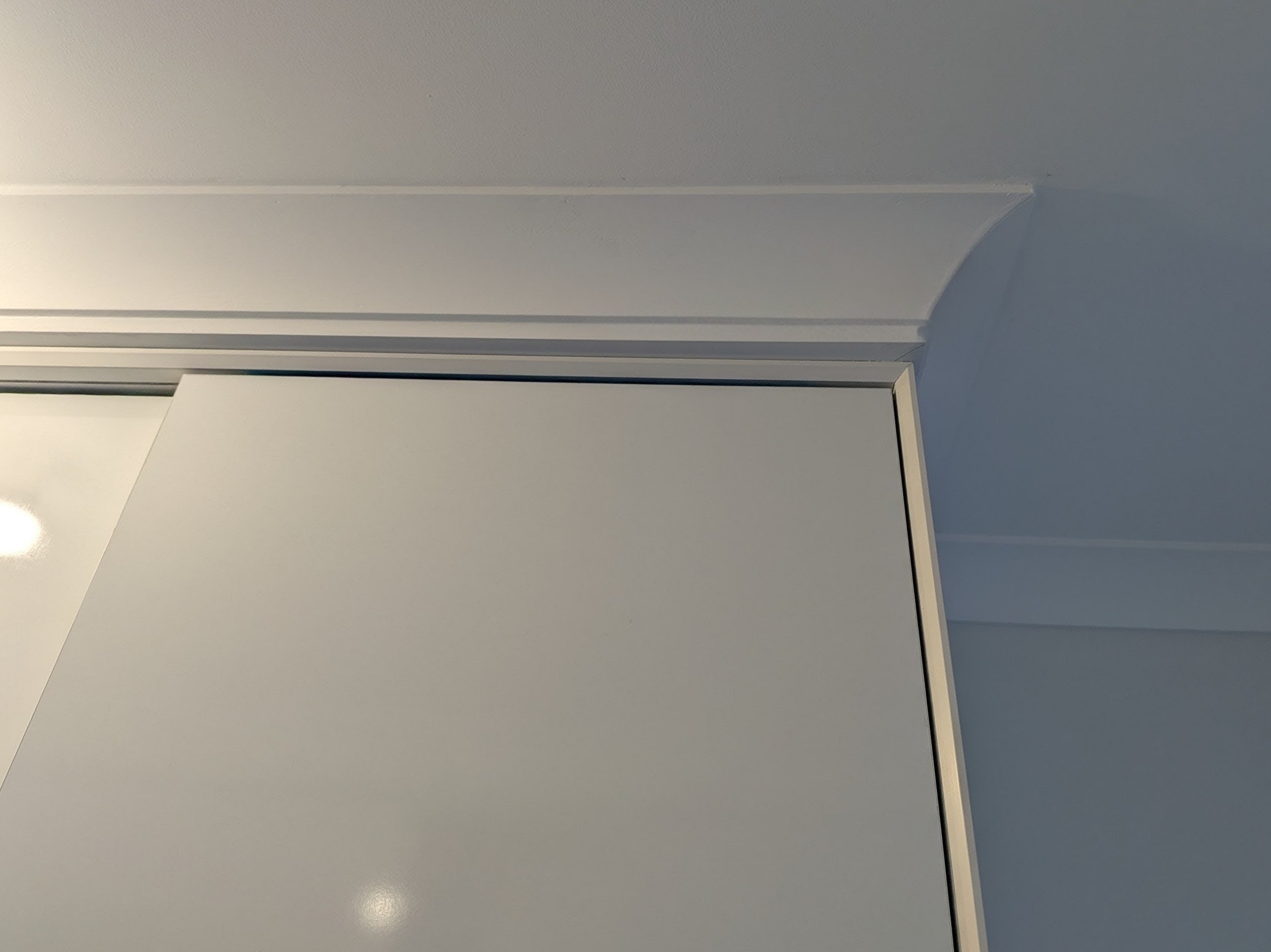 Premium built-in wardrobe featuring concealed sliding door track and seamless shark nose edge detail in Shellharbour