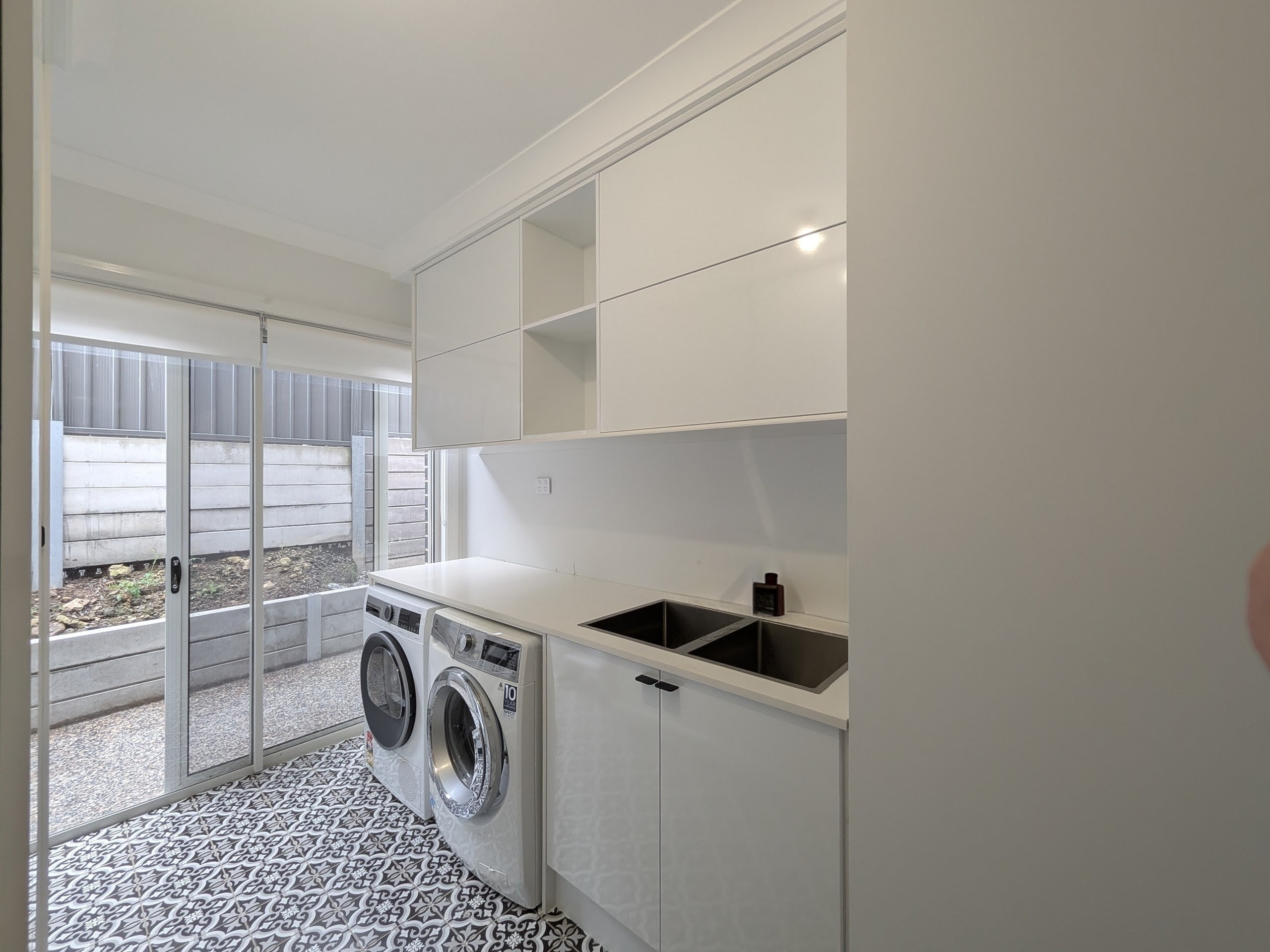 Custom laundry cabinetry with integrated storage solutions in Shellharbour NSW.
