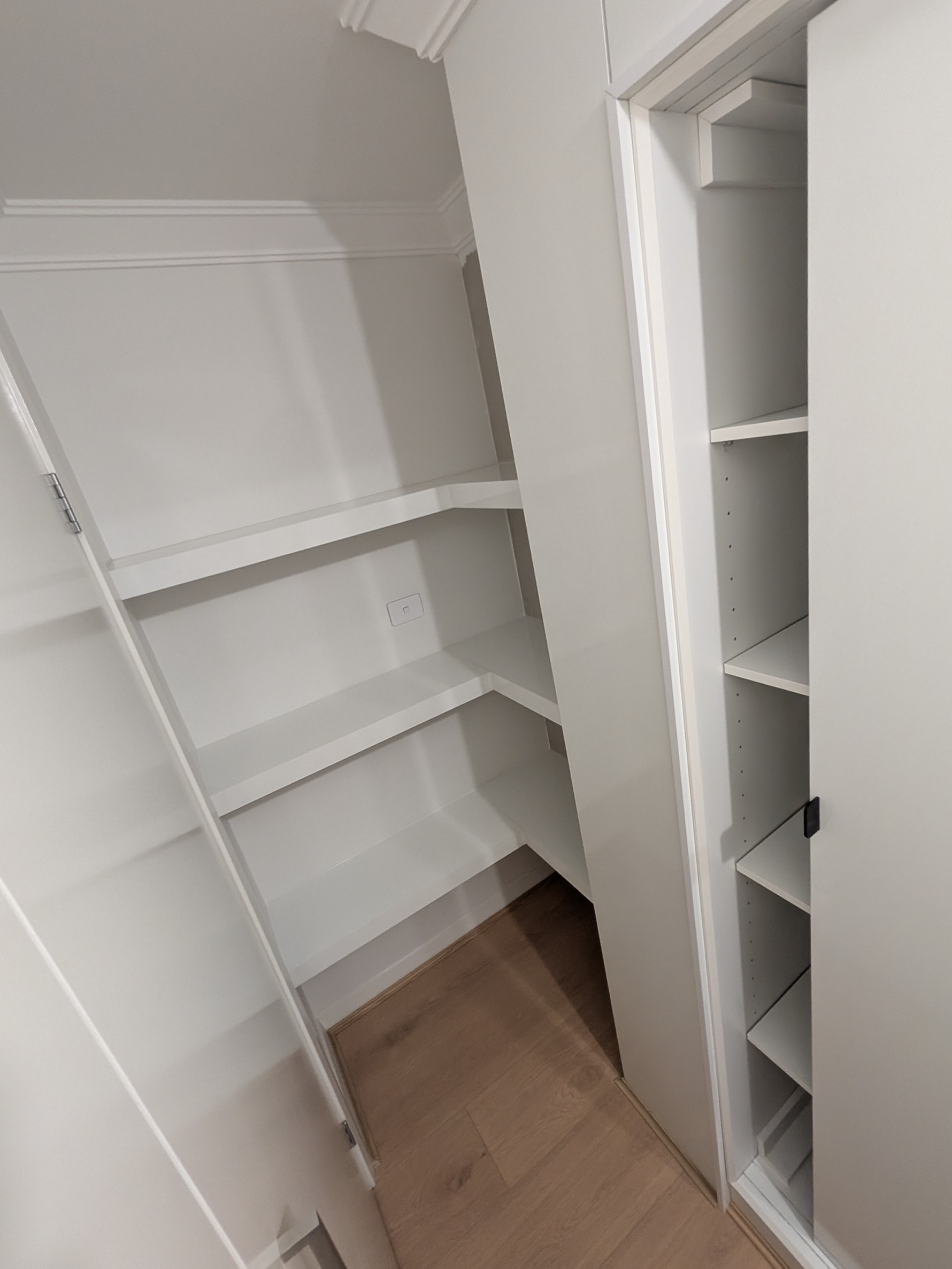 Custom walk-in wardrobe with adjustable shelving, sliding door system, and space-efficient storage design in Shellharbour NSW