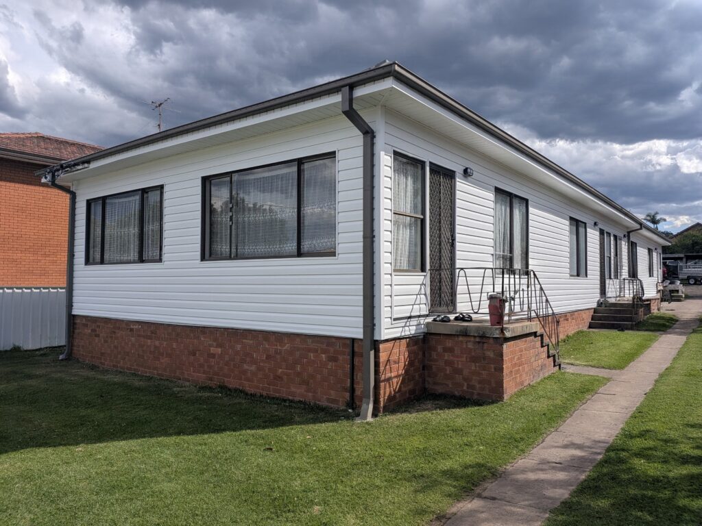 White vinyl cladding installation transforming an older home exterior in Wollongong